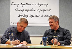 Kaibab National Forest Supervisor Mike Williams and  Coconino National Forest Supervisor Earl Stewart sign the final record of decision for 4FRI’s first Environmental Impact Statement April 17 in Flagstaff. Photo/U.S. Forest Service