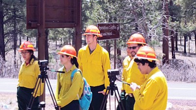 Grand Canyon School videography teacher Bently Monk watches as students adjust camera settings.  Photo/Amala Posey