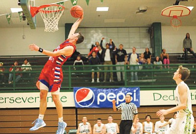 Grand Canyon School senior Tyler Jones makes a slam dunk during the 2014 Pepsi Tournament. Loretta Yerian/WGCN