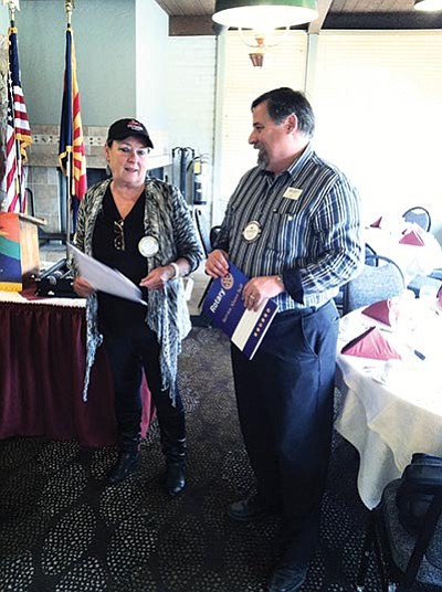 Rotary president Clayann Cook inducts Grand Canyon resident Jim Stellmack. Photo/Rob Gossard