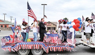 A red, white and blue float passes down Main Street in Tusayan for the Fourth of July parade. Photo/Yvonne Trujillo