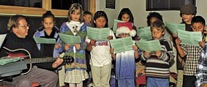 Grand Canyon School music teacher George Haughton leads students in a presentation of holiday music at last year’s Holiday Open House hosted by Grand Canyon Association. This year’s event is next Monday, from 6:30-8:30 p.m. at Canyon View Information Plaza.