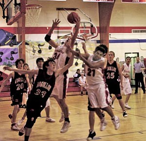 Phantom varsity boys Bille Booth and Cruz Caballero try to gain ground on the Mogollon Mustangs. Below, Marissa Timeche struggles for possession of the ball.