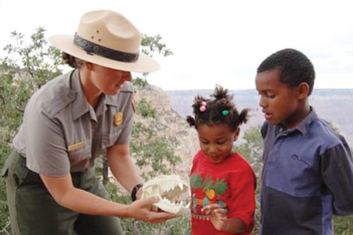 Photo courtesy National Park Service
Ranger Jessica Collins shares a mountain lion skull with Jakiah and Dante Smith Evans.