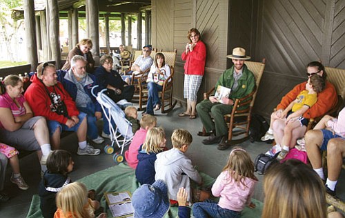 <br>Patrick Whitehurst/WGCN<br>
Park Ranger Nick Fuechsel reads to children and parents during Storytime Adventures on the deck of the El Tovar June 20.