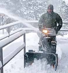 <br>Photo by Mike Quinn/NPS<br>
Park Ranger Patrick Gamman clears public restroom entrances with a snow blower during the recent snow storms that moved across northern Arizona Jan. 18-24.