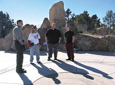 Photo/Abby Confer<br>
From left, District Ranger Ira Blitzblau, Bill Barber, Special Olympics CEO Tim Martin and son Chase Martin discuss Torch Run logistics at Mather Point, where the run will begin.

