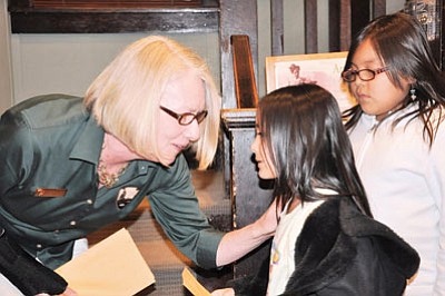 Photo/Bill Brookins<br>
Grand Canyon National Park Acting Superintendent Jane Lyder congratulates student artists.