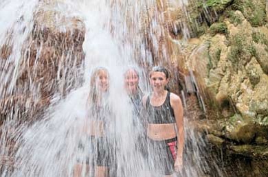 Grand Canyon Youth participants cool off under a waterfall in a side canyon off of the Colorado River during last year’s<br /><br /><!-- 1upcrlf2 -->rafting trip.