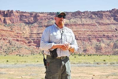 Photo/George Hardeen<br>
Chris Parish, field director of The Peregrine Fund’s Condor Project, points out the release site high on the Vermillion Cliffs where three young condors were released on Sept. 24.