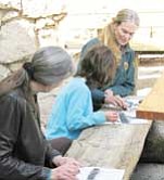 Photo/National Park Service<br /><br /><!-- 1upcrlf2 -->North Rim Artist in Residence Jennifer Carney teaches visitors to sketch using charred wood from a forest fire.