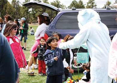 The Easter Bunny hands out prizes and candy during last year’s egg hunt at Grand Canyon School.