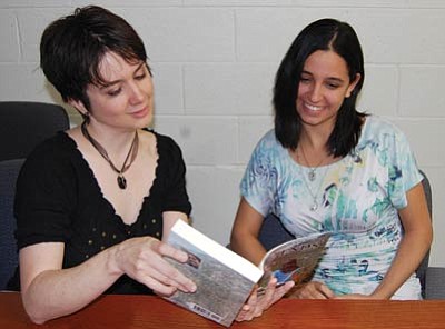 Writers Stephanie Cress, left, and Alexandra Livingston discuss the respective novels they will present at this weekend’s Kingman Area Books Are Magic Festival. (DOUG McMURDO/Miner)