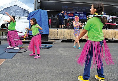 Matt Hinshaw/The Daily Courier<br>
From left, Carolina Quiroz, 11, Andrea Pozos, 8, and Anna Rebeca Valle, 8, visiting Prescott from Sonora, Mexico dance with hula-hoops during the 2012 Firehouse Luau.