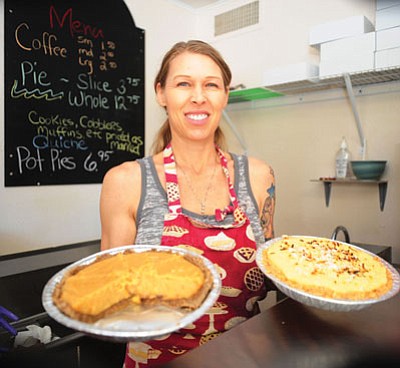 Owner and head cook Kim Pinker holds a coconut pie and a vanilla carmel pie at the Rustic Pie Co. on Valley Street.  Below left is a strawberry pie, and below right is the mixed berry pie.<br>
Les Stukenberg/The Daily Courier