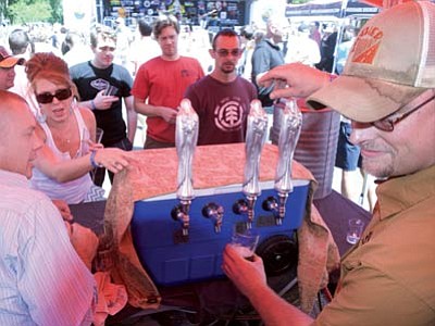 Mother Road Brewing serves up some libations during the 2013 Mile High Brewfest in downtown Prescott. This year’s third installment is Saturday, Aug. 16. (Les Stukenberg/The Daily Courier)