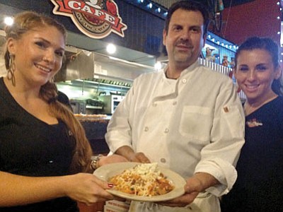 Dominick Anzelmo of Rosa’s is flanked by daughters Graziella, left, and Mariastella, right. Dominick’s wife, Rosa, is not pictured (she was home cooking). (Tom Scanlon/The Daily Courier)