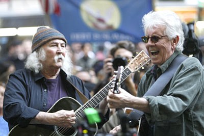 Mary Altaffer/The Associated Press<br>On Nov. 8, singers David Crosby, left, and Graham Nash perform at the Occupy Wall Street encampment at Zuccotti Park in New York. Music is woven into the fabric of Occupy Wall Street, much like when civil rights protesters sang "We Shall Overcome" or 1960s demonstrators heard "Blowin' in the Wind" or "Give Peace a Chance." Crosby and Nash's manager sent an email to Occupy Wall Street's website asking if the musicians could perform.
