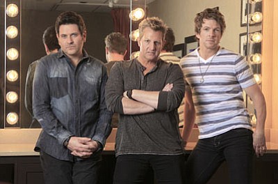Mark Humphrey/The Associated Press<br>This Feb. 27, 2012 photo shows Jay Demarcus, left, Gary Levox, center, and Joe Don Rooney, right, of the trio Rascal Flatts, in a dressing room at the Grand Ole Opry House in Nashville, Tenn. Their eighth studio album, "Changed," is the second album since they joined Big Machine Records, but the first they conceived and recorded since the collapse of their label Lyric Street and their switch of managers to Clarence Spalding.
