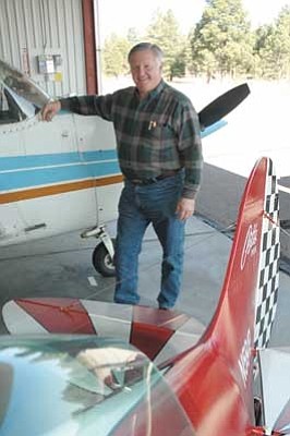 Larry Deibel with his plane at a hangar in Flagstaff