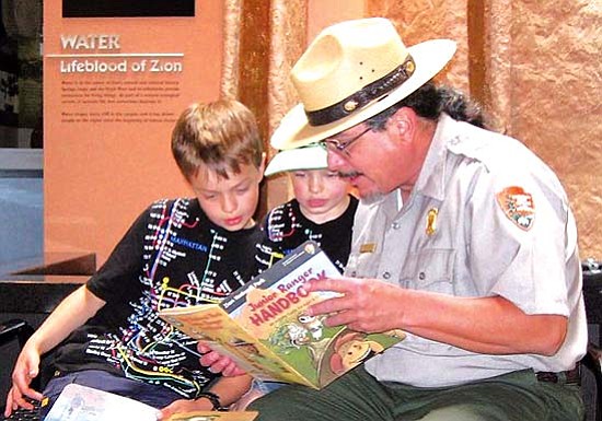 <i>Courtesy photo</i><br>
A National Park Service ranger goes over the Junior Ranger Handbook with a couple of potential junior rangers. The 2009 Teacher-Ranger-Teacher Program is currently seeking qualified teachers in and around Flagstaff to apply for the program. The deadline to apply is Sunday, Feb. 1.