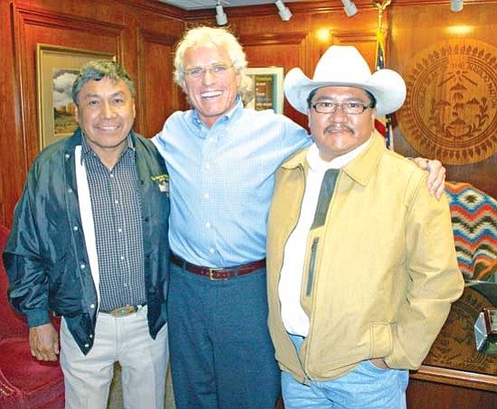 <i>Photo by Christian Bigwater</i><br>
Navajo Nation Council Delegates Harry Claw (left) and Thomas Walker Jr. (right) stand with Joseph P. Kennedy II, president of Citizens Energy Corp.