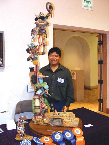 <i>Rosanda Suetopka Thayer/NHO</i><br>
Adrian Nasafotie poses with his award winnning carving entitled "Quest," which took Best of Show honors at the 76th Annual Hopi Festival of Arts and Culture held this past weekend at the Museum of Northern Arizona.