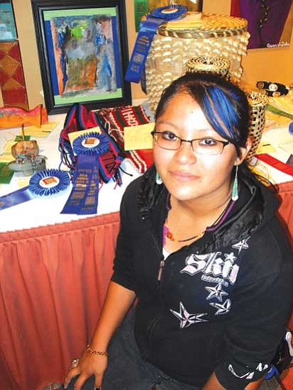Alicia Nequatewa is an up and coming artist at Indian Market. She won first and second place in the Youth Division for her belt textile work.