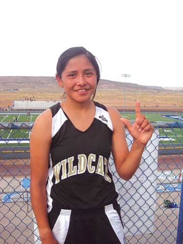 <i>Stan Bindell/NHO</i><br>
Rolanda Jumbo of Chinle shows she is number one after winning the Hopi Invite in the girls race.