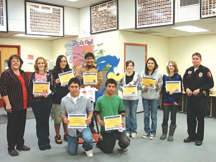 Kneeling (left to right): Joshua Lerma (Physical Education) and Michael Shorty (Reading). Standing (left to right): Ms. Leann Turley (HHS Administrative Assistant), Emily Miller (Fine Arts), Tonisha Haley (Career Technical Education), (Standing behind "Ronnie the Roadrunner) Garrison Yazzie (NAVIT), Meliea Rhein (Math), Amanda Chee (English), Mariah Hatch (Science), and SRO Everett Olson. Not pictured: David Hatch (Spanish), Darrell Begay (Writing), and Alyssa Benavidez (Social Studies).