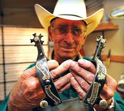 <i>Todd Roth/NHO</i><br>
Leon King, who has over 50 years of experience in making hand-made spurs, shows a pair of his "famous" spurs. He got his start after purchasing an inferior pair of spurs from a mail-order catalog. Today, he produces about 25 pairs a year. Among the notables who own King spurs is former Navajo Nation President and State Sen. Albert Hale.