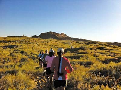 <i>Rosanda Suetopka Thayer</i><br>
Runners blaze a trail during the historic <i>Paatuwa’qatsi</i> Run through ancient mesa back roads near Walpi, Sichomovi and Hano. The sun was just coming up over the mesa top when the runners left their starting point.