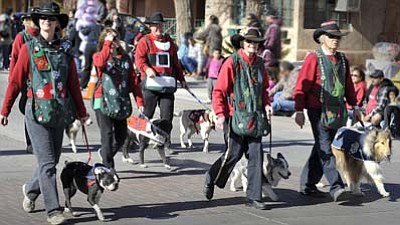 <i>Todd Roth/NHO</i><br>
The Flagstaff Kennel Club K-9 Drill Team makes their way down the parade route on Nov. 20 during the 64th Annual Winslow Christmas Parade.
