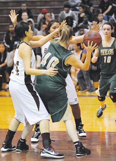 <i>Todd Roth/NHO</i><br>
A Show Low Lady Cougar player attempts to pass the ball to another Lady Cougar while blocked by a couple of Winslow Lady Bulldogs. The Lady Bulldogs pulled off an impressive 78-24 win over the Lady Cougars in Winslow.