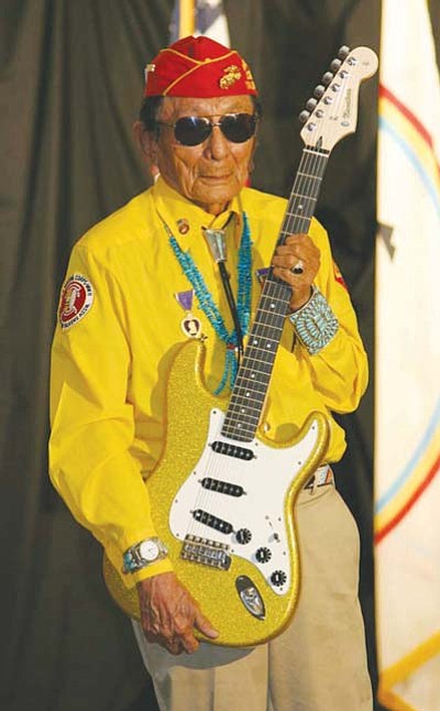 <i>Courtesy photo</i><br>
Navajo Code Talker Samuel Tom Holiday holds up a one-of-a-kind guitar created by Navajo artist Shonie De La Rosa in honor of the Navajo Code Talkers and their distinguished military service during WWII. The guitar, which will be signed by all surviving Navajo Code Talkers, will be placed on display at the Navajo Code Talkers Museum in Window Rock.