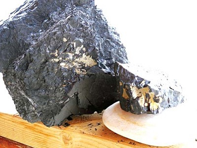 <i>Rosanda Suetopka Thayer/NHO</i><br>
Flecks of iron pyrite can clearly be seen in chunks of coal being hauled from the Peabody Mine for home heating use by both Hopis and Navajos. The burning of coal to heat homes was more prevalent than ever this past year, but there is currently no information available as to any possible hazards to humans from the burning of iron pyrite, which was once used as a source of ignition for firearms. Iron pyrite, which can sometimes take on a golden color, is also known as “Fool’s gold.”