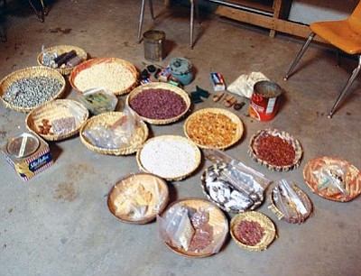 Baskets full of ancient organic Hopi seeds are blessed after the early morning run at First Mesa in Tewa Village. This year, however, due to inclement weather, the seeds had to be taken inside one of their kivas to keep them dry during the blessing, but are usually “smoked” over in the open village plaza.