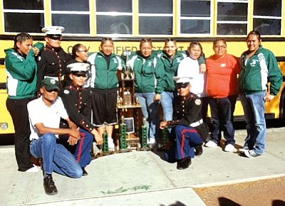 <i>Courtesy photo</i><br>
Cadets from the Marine Corps Junior Reserve Officer Training Corps (MCJROTC) from Tuba City High School pose in front of their bus with their trophy. The MCJROTC Drill Team recently competed in the Desert Classic JROTC Arizona State High School Drill Championship in Phoenix and won the Championship Sweepstakes trophy for the fifth time since 2003, maintaining the legacy of the Tuba City Warriors.