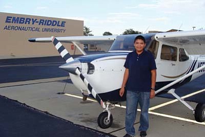 Photo/George Hardeen<br>
Tyler Allen, 16-year-old Window Rock High School junior, attended the Embry-Riddle Aeronautical University Flight Exploration Program in Prescott this summer. He was assisted by a scholarship from the Page/Lake Powell Community Foundation Navajo Youth Achievement Fund. Behind him is a Cessna 172SP Skyhawk from the of Embry-Riddle fleet. .