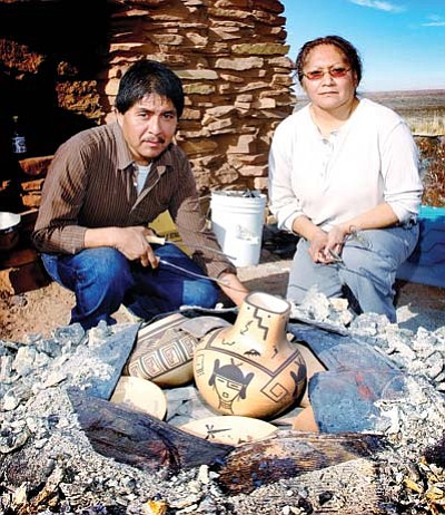 Todd Roth/NHO<br>
Dee Setalla and Gwen Setalla uncover their traditionally created Hopi ceramics Jan. 3 at Homlovi State Park.
