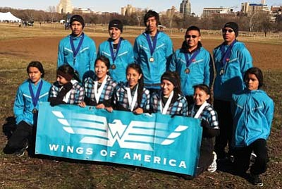 Members of Wings of America who traveled to St. Louis pose for a team picture to showcase their medal after the race.