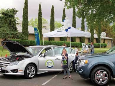 Hannah Reddington, daughter of Lake Powell Ford General Manager Dan Riddington, helps out during last year’s Drive One 4 UR School with Page High School.