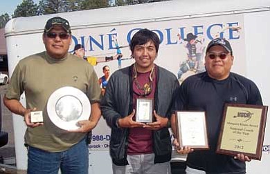 From left, Diné College Assistant Coach Anthony Goldtooth, Rookie of the Year Ben Smith and Head Coach Fray Gray show off some of their recent awards presented to them at the United States Inter-Collegiate Archery (USIAC) Championships held at Harrisonburg, Va. <i>Photo/Derren Wauneka</i>