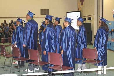 White Cone graduates stand for the Pledge of Allegiance during commencement ceremonies May 21. <i>Submitted photo</i>