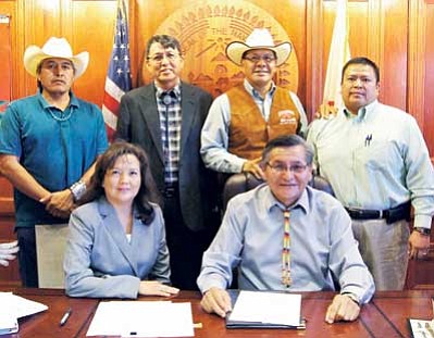 (Left to right) Council Delegates Elmer Begay, Walter Phelps, Lorenzo Curley, and Alton Joe Shepherd, join (front left) BIA Navajo Regional Director Sharon Pinto and (front right) Navajo Nation President Ben Shelly for the signing Monday morning. Submitted photo