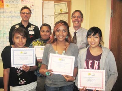 Hopi High broadcast radio students show off their state awards. Pictured from left: Otivia “Big Oh” Puhuhefvaya, Janine “Rabbit” Shula, Christina Rucker and Shacely Miguel. Back row: KUYI Station Manager Richard Davis and Hopi High Principal Glenn Gilman celebrate with the studnts. Submitted photo