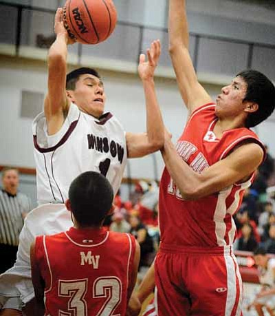 Michael Goldtooth drives to the basket. Photo/Todd Roth