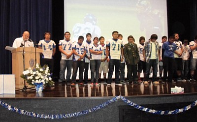 Hopi High football coach Steve Saban and the Hopi football team stand on stage at a Nov. 13 to honor Hopi High football player Charles Youvella who died after sustaining a head injury during a playoff game last weekend. Photo/Stan Bindell<br /><br /><!-- 1upcrlf2 --><br /><br /><!-- 1upcrlf2 -->