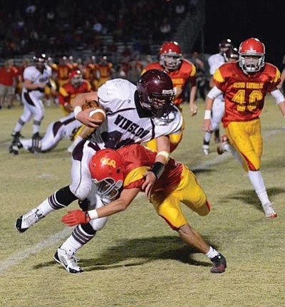 Winslow’s Kelly Wood breaks away from Seton Catholic defenders. Wood ran for 312 yards during the Bulldogs’ Nov. 16 27-20 loss. Photo/Todd Roth