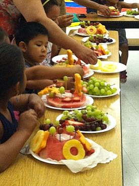 Young children who participated in NEOPP, make a delicious and healthy watermelon cake.
